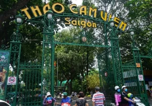 Green ornate gate reading 'THAO CAM VIEN Saigon' opens into a tree-filled park area.