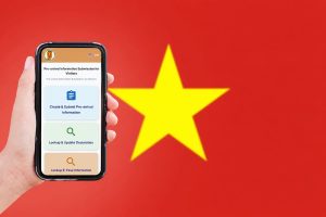 Hand holding a smartphone showing an app screen for pre-arrival information, with options to Create & Submit, Lookup, and E-Pass information, against a red background with a yellow star (Vietnam flag).