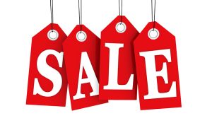 Red sale tags hanging on strings spell the word SALE