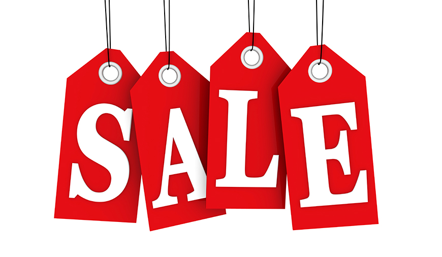 Red sale tags hanging on strings spell the word SALE